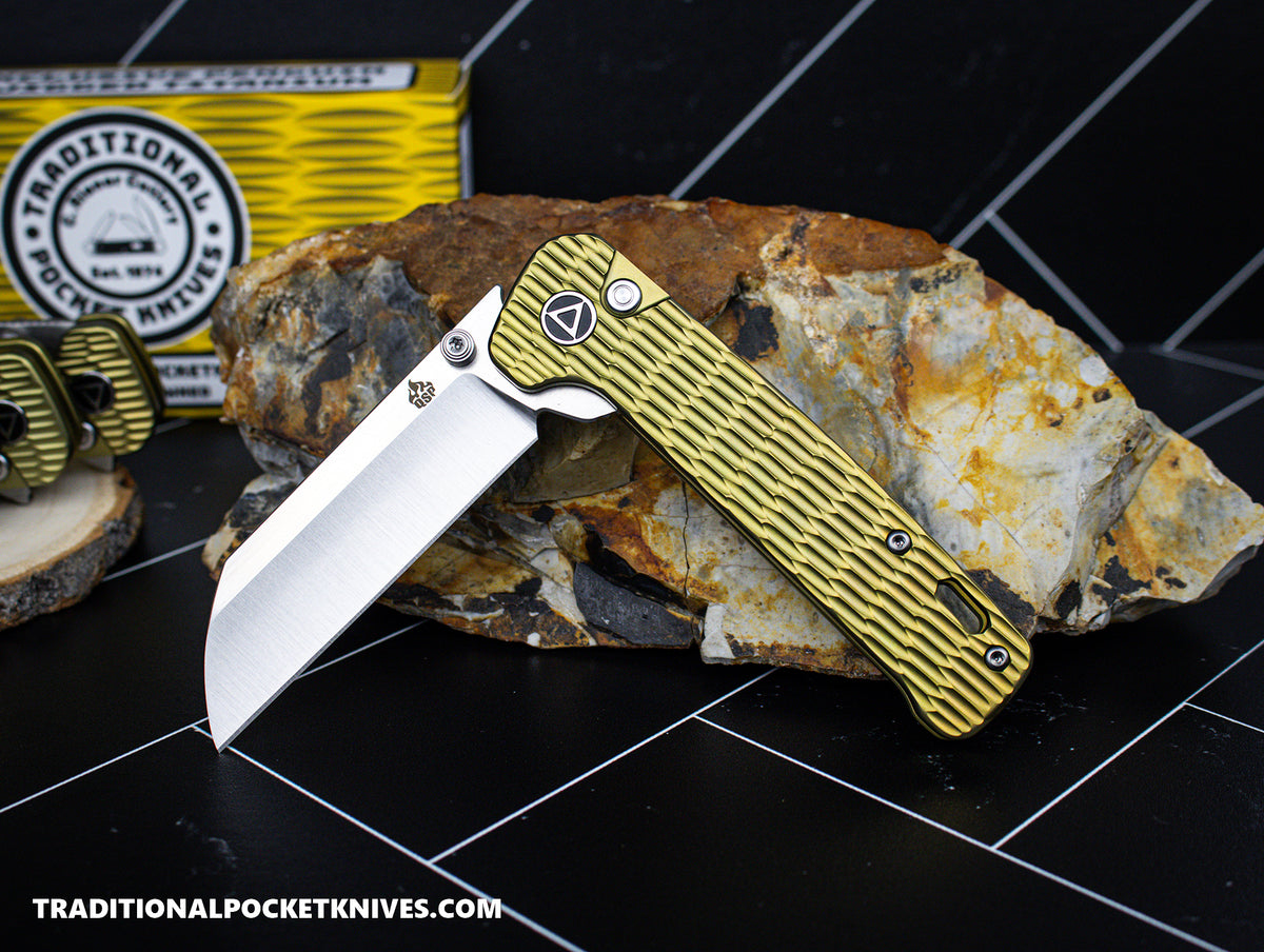 QSP Exclusive Penguin Button Lock Knife Gold Jigged Titanium